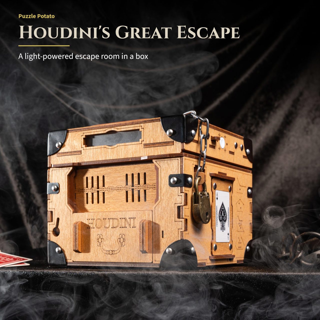 Houdini's Great Escape: a light-powered escape room in a box. The chained and padlocked puzzle box standing in drifting smoke.