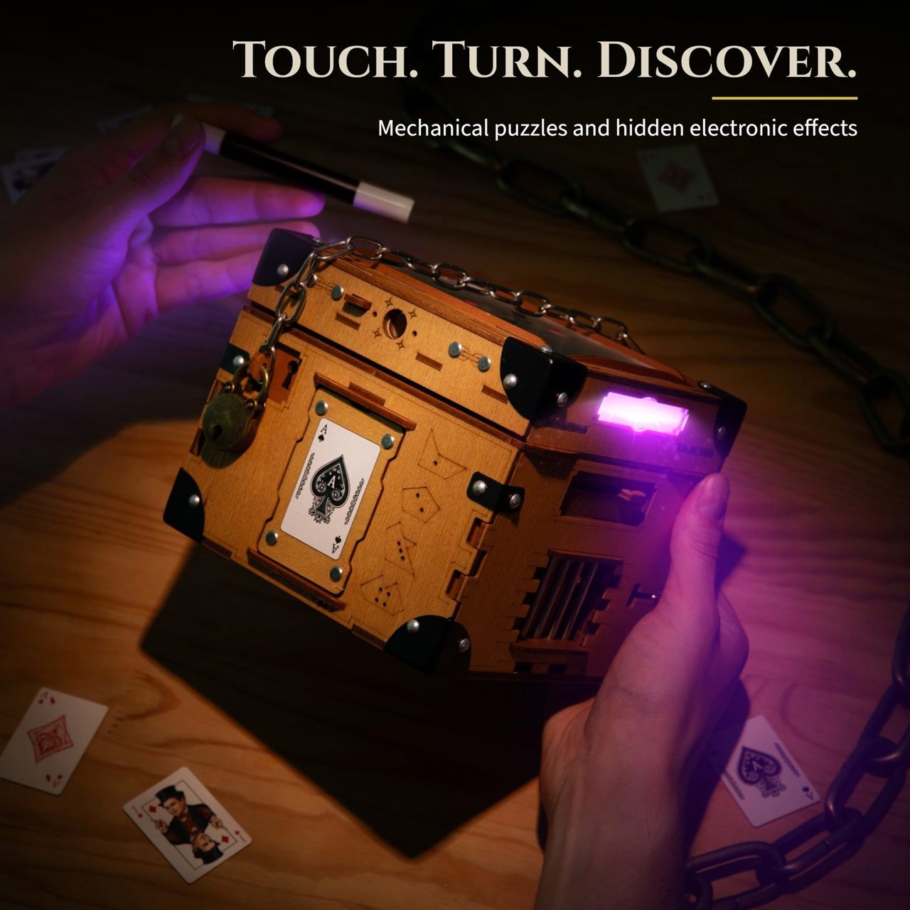 Touch. Turn. Discover: mechanical puzzles and hidden electronic effects. Hands hold the box in the dark as violet light glows from a slot in its side.